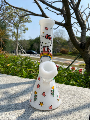 White beaker bong by Croia Glass featuring a cute Hello Kitty design with playful accents and a smooth finish.