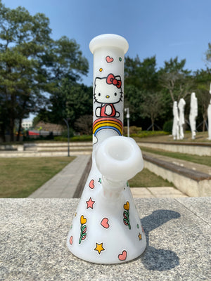 White beaker bong featuring a cute design by Croia Glass with Hello Kitty accents and a smooth, glossy finish.